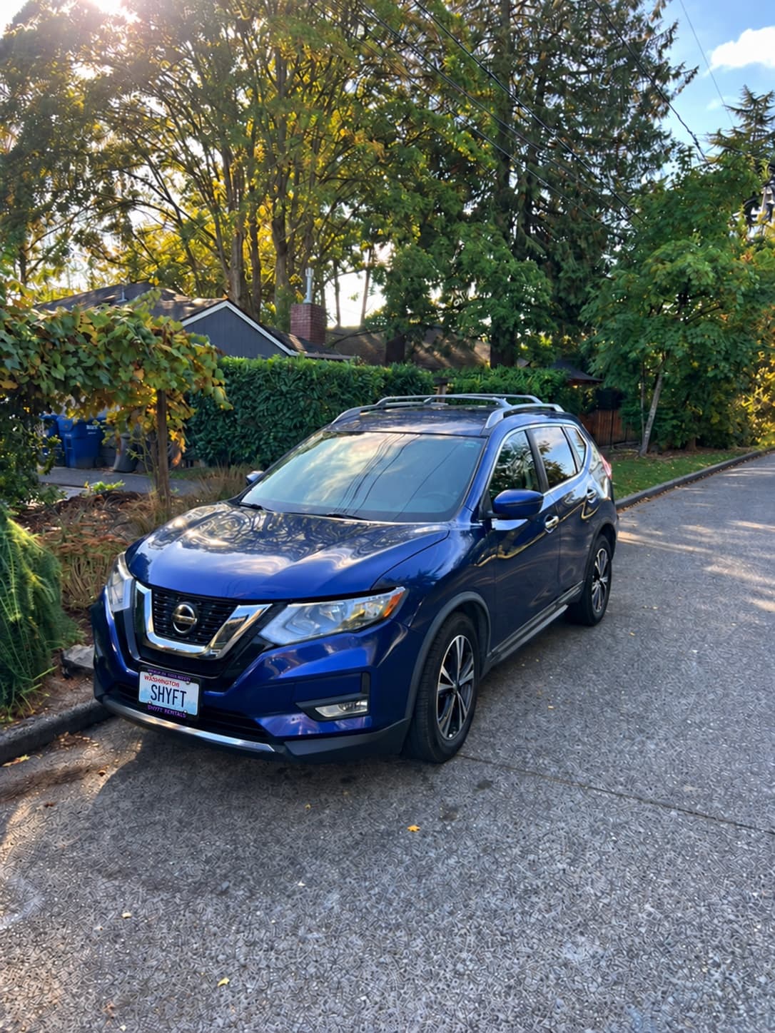 Our blue Nissan Rogue with a SHYFT plate, parked in Seattle